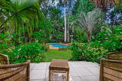a patio with a table and chairs and a pool at Spurflower in Tzaneen