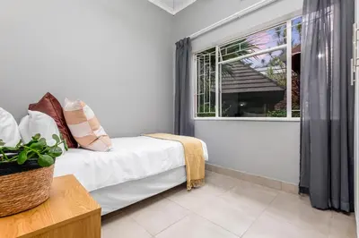 a room with a bed and a window at Spurflower in Tzaneen