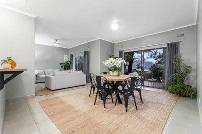 a dining room with a table and chairs at Spurflower in Tzaneen