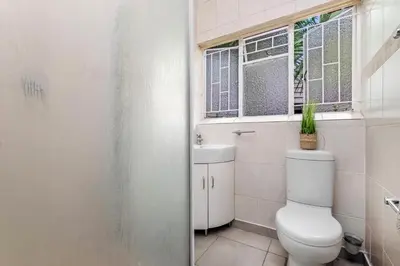 a bathroom with a toilet and a window at Spurflower in Tzaneen