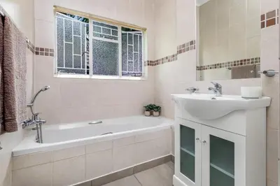 a bathroom with a sink and a tub and a sink at Spurflower in Tzaneen