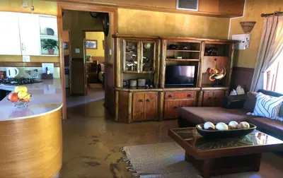 a living room with a couch and a table at Golf View Guest House in Musina