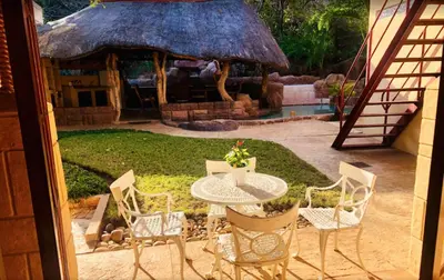 a patio with a table and chairs and a gazebo at Golf View Guest House in Musina