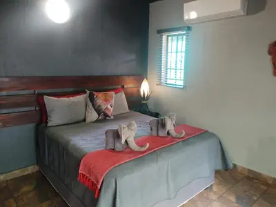 two stuffed animals sitting on a bed in a bedroom at 2694 Marloth Park Family Villa in Marloth Park