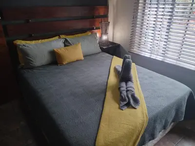 a stuffed animal is laying on a bed at 2694 Marloth Park Family Villa in Marloth Park
