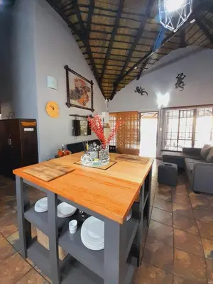 a kitchen with a wooden table in a room at 2694 Marloth Park Family Villa in Marloth Park