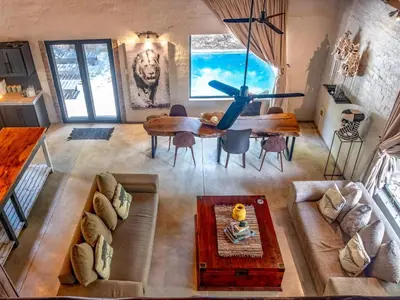 an overhead view of a living room with a table and chairs at Croc Orvyll's Kruger Lodge in Marloth Park
