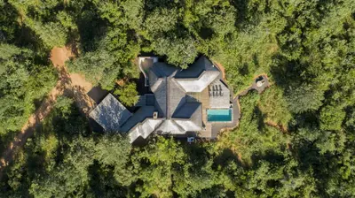 an aerial view of a large house in the forest at Villa Blaaskans in Hoedspruit