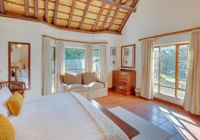 a large bedroom with a large bed and a couch at Zebula 1 Pela Lodge, 4-bedroom house in Warmbaths