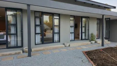 a house with a row of windows on it at GrootBoom Guest Rooms in Pretoria