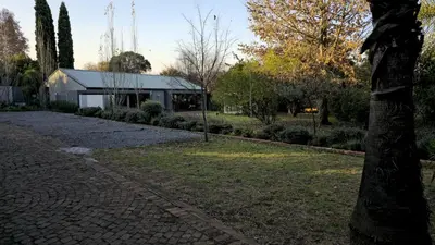 a brick driveway with a building in the background at Grootboom Guest Rooms in Pretoria