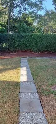 a stepping stone path in the grass in a park at Villa paradiso 1 in Centurion