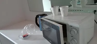 a microwave with styrofoam cups on top of it at Villa paradiso 1 in Centurion