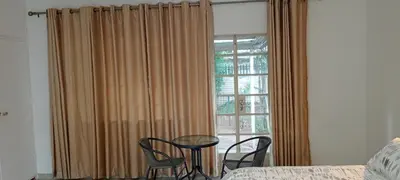 a bedroom with a window with two chairs and a table at Villa paradiso 1 in Centurion