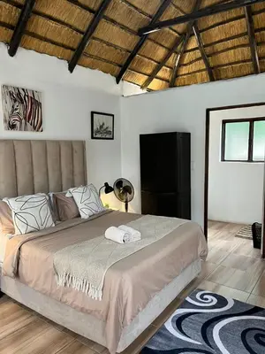 a bedroom with a large bed in a room at Aero Ensuites- OR Tambo in Kempton Park