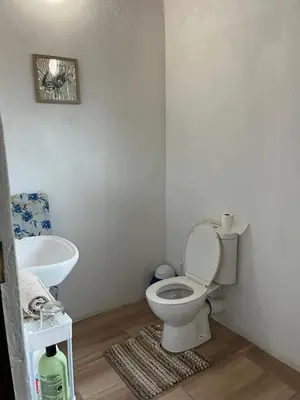 a bathroom with a toilet and a sink at Aero Ensuites- OR Tambo in Kempton Park