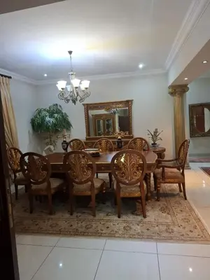 a dining room with a wooden table and chairs at Aaybee for Four in Midrand