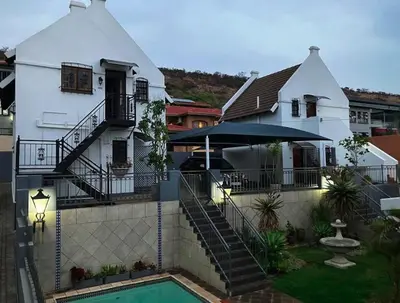 a white house with a pool in front of it at Montana Cape House in Pretoria