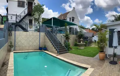 a house with a swimming pool in front of a house at Montana Cape House in Pretoria