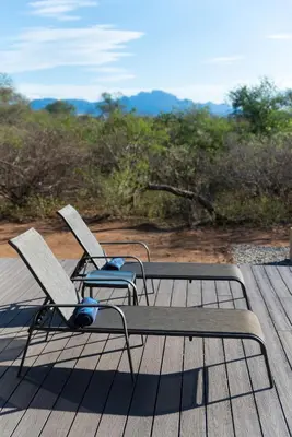 two chairs sitting on top of a wooden deck at Villa Marula in Hoedspruit