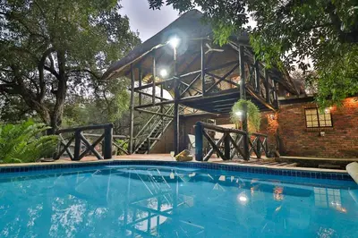 a large swimming pool in front of a building at Qëtesia- Oasis of tranquility in Marloth Park