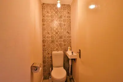 a bathroom with a toilet and a sink at Qëtesia- Oasis of tranquility in Marloth Park