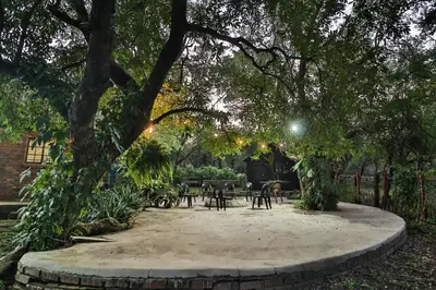 a park with a table and chairs under a tree at Qëtesia- Oasis of tranquility in Marloth Park