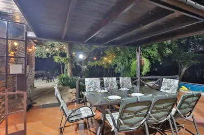 a patio with a table and chairs under a pergola at Qëtesia- Oasis of tranquility in Marloth Park