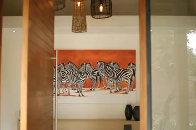 a painting of a group of zebras on a wall at Villa Scarabee in Hoedspruit