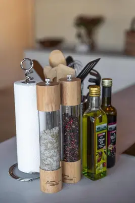 a counter with a roll of paper towels and spices at Villa Scarabee in Hoedspruit