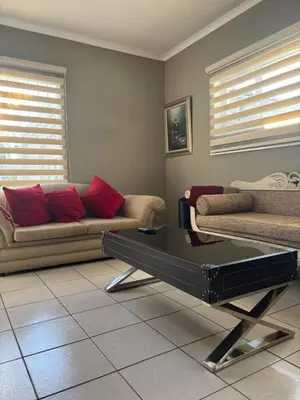 a living room with two couches and a coffee table at Top Building in Pretoria