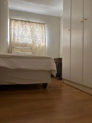 a bedroom with a bed and a window at Top Building in Pretoria