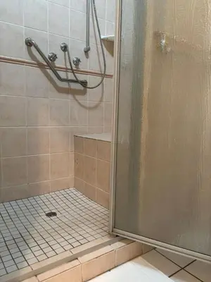 a shower with a glass door in a bathroom at Top Building in Pretoria