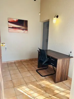 an office with a desk in a room at Exquisite cottage in Doringkloof in Centurion