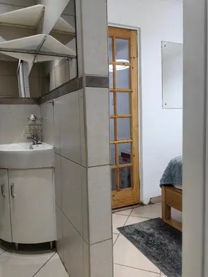 a bathroom with a sink and a mirror at EasyStay Hideaway in Pretoria