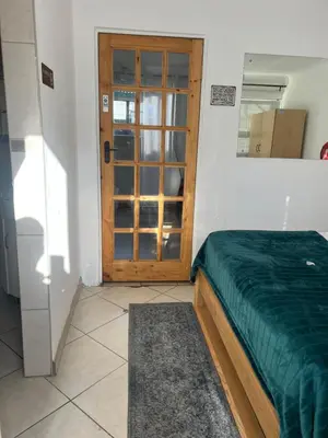 a bedroom with a bed and a door with a window at EasyStay Hideaway in Pretoria