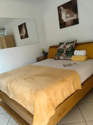 a bedroom with a bed with a wooden frame at EasyStay Hideaway in Pretoria