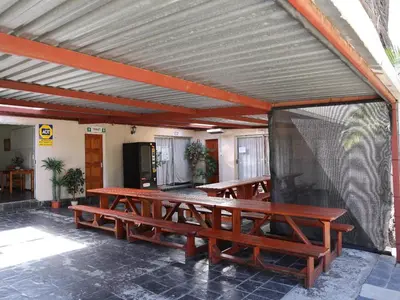 a group of picnic tables in a patio at Malembe Lodge in Midrand
