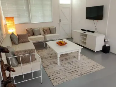 a living room with a couch and a table at TarRoadEnds in Hoedspruit