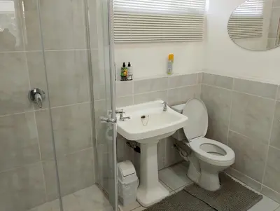 a bathroom with a toilet and a sink and a shower at TarRoadEnds in Hoedspruit