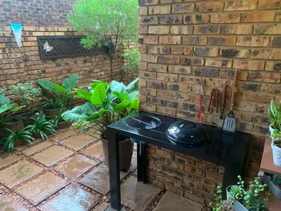 a black table in front of a brick wall at Dobbs Lodge in Centurion