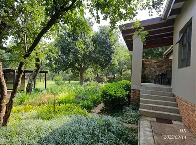 a garden outside of a house with plants at Riverside Self-Catering Accommodation