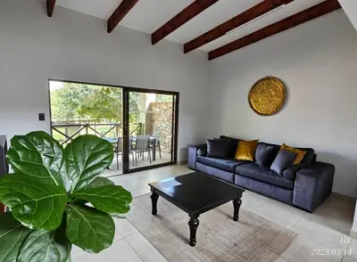 a living room with a couch and a table at Riverside Self-Catering Accommodation