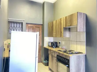 a kitchen with a stove and a refrigerator at A spacious 2bedrooms apartment in the heart of Kempton Park in Kempton Park