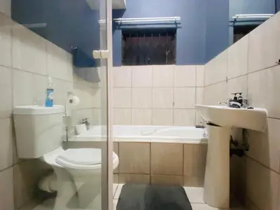 a bathroom with a toilet and a sink at A spacious 2bedrooms apartment in the heart of Kempton Park in Kempton Park