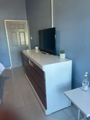 a kitchen with a white counter with a tv on it at Lupulo luxury boutique in Thohoyandou