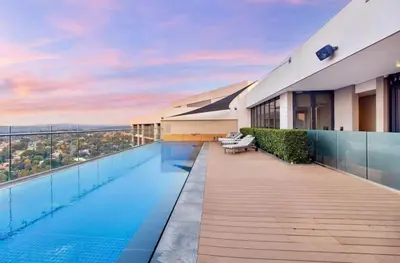 a large building with a swimming pool on top of it at Menlyn Maine Luxury Apartment in Pretoria
