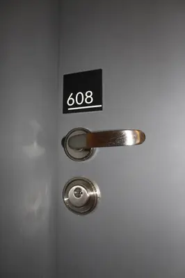 a door with a door knob and a sign on it at Menlyn Maine Luxury Apartment in Pretoria