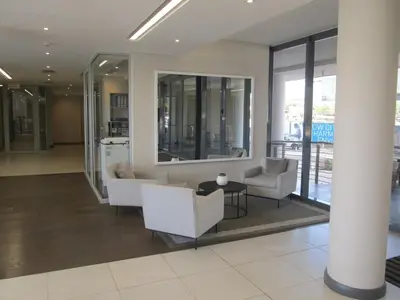 a lobby with couches and a table in a building at Menlyn Maine Luxury Apartment in Pretoria