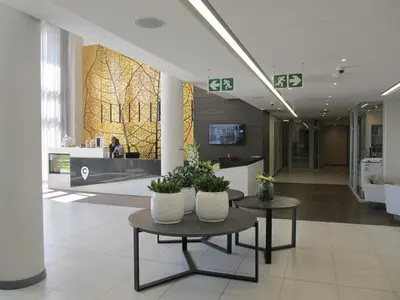 a lobby with two tables with plants on it at Menlyn Maine Luxury Apartment in Pretoria
